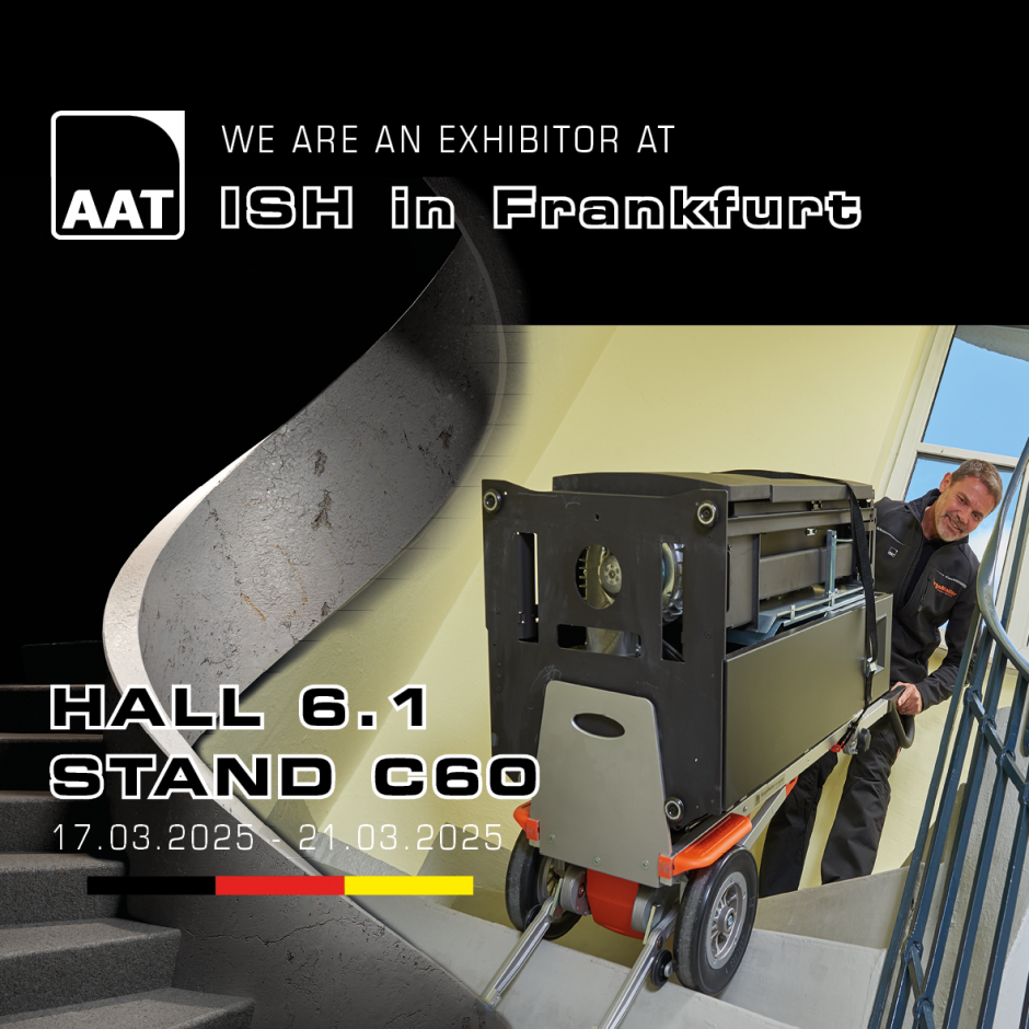 The image shows a middle-aged man effortlessly carrying a large oven down a spiral staircase using our CargoMaster stair climber. The image also includes details about when and where we will be at the ISH trade fair.