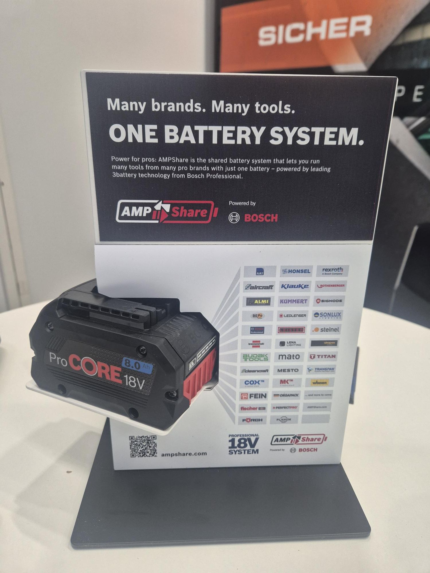 The image shows a Bosch AMP Share battery and all the partners participating in the AMP Share program.